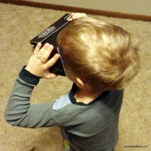Nolan playing with Verizon's Star Wars Cardboard viewer